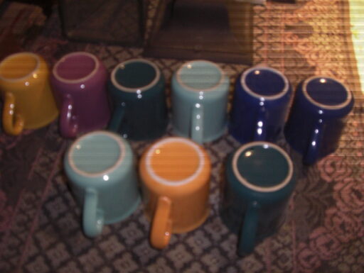 Tazze con manico, in colori vari.lotto di nove